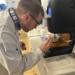 Our lab manager trimming a sample on a rheometer.